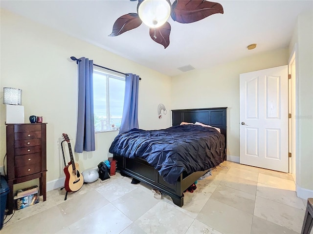 tiled bedroom featuring ceiling fan