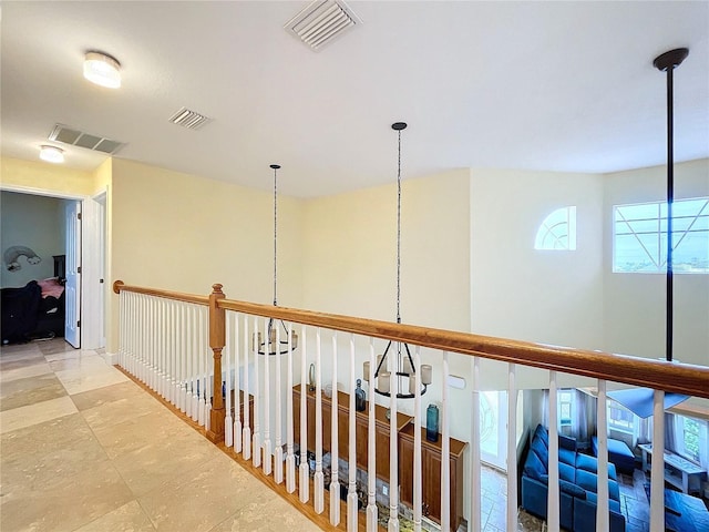 corridor with a notable chandelier