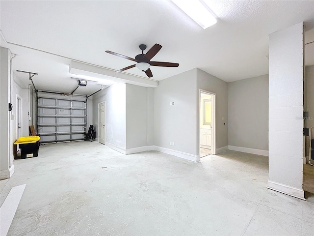 garage featuring a garage door opener and ceiling fan