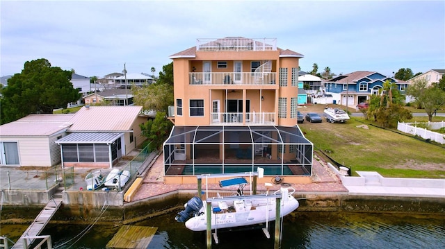 rear view of property featuring a water view, a lanai, and a patio area