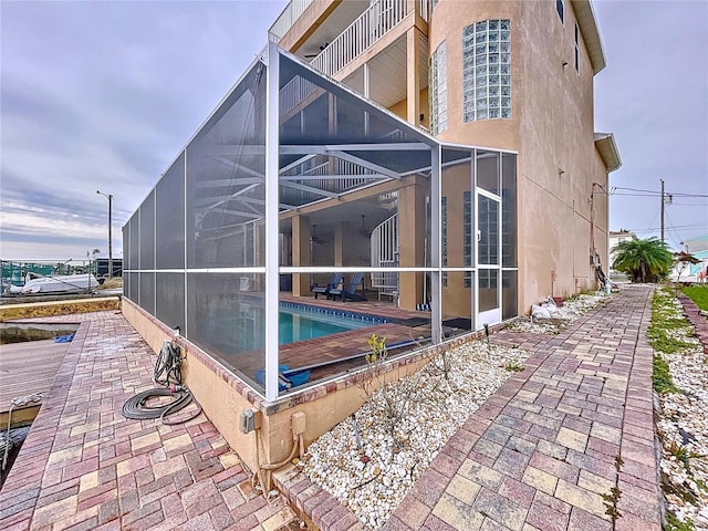 view of pool with a patio and glass enclosure