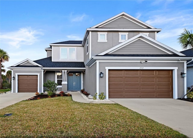 view of front facade with a front yard and a garage