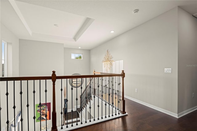 hallway featuring dark hardwood / wood-style flooring and a raised ceiling