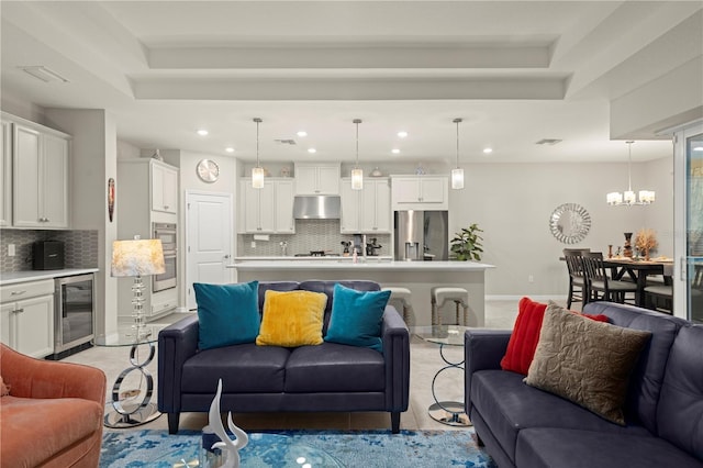 living room with beverage cooler and an inviting chandelier