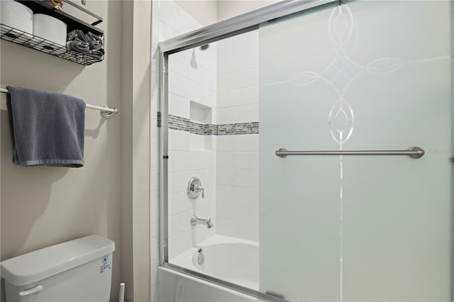 bathroom featuring shower / bath combination with glass door and toilet