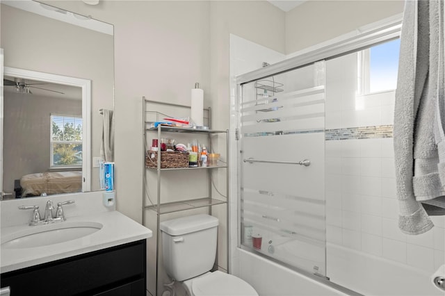 full bathroom with ceiling fan, toilet, vanity, and combined bath / shower with glass door