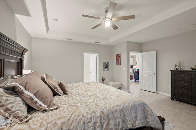 tiled bedroom with a raised ceiling and ceiling fan