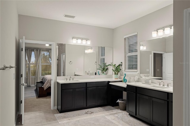 bathroom with tile patterned floors and vanity