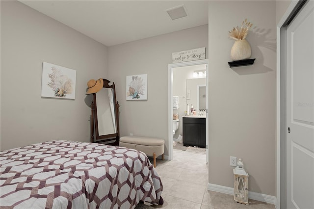 tiled bedroom featuring ensuite bathroom and a closet