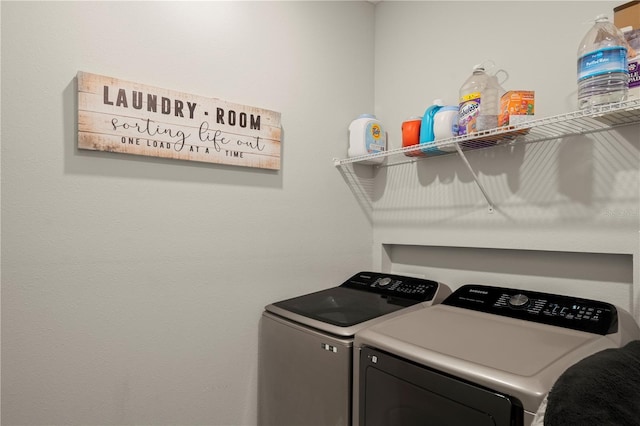 washroom with washing machine and clothes dryer