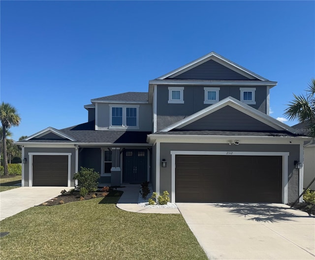 traditional-style home with an attached garage, a front yard, concrete driveway, and stucco siding