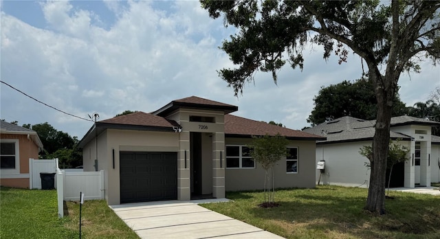 view of front of home featuring a garage and a front lawn