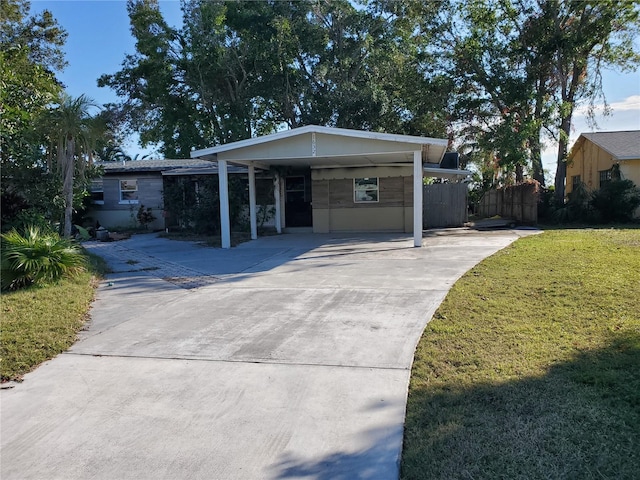 single story home with a front yard and a carport