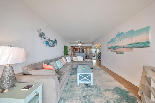 living room with ceiling fan and hardwood / wood-style floors