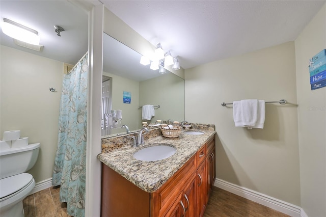 bathroom featuring toilet, vanity, a chandelier, and hardwood / wood-style flooring