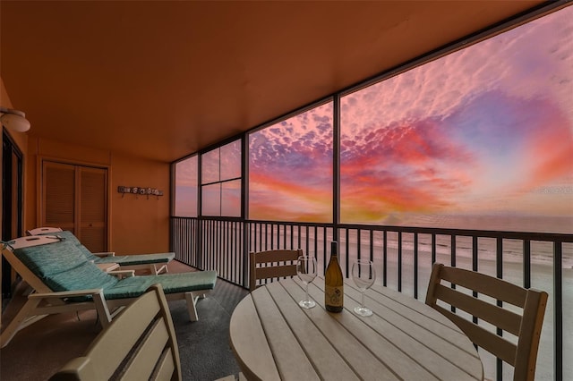 sunroom / solarium featuring a water view