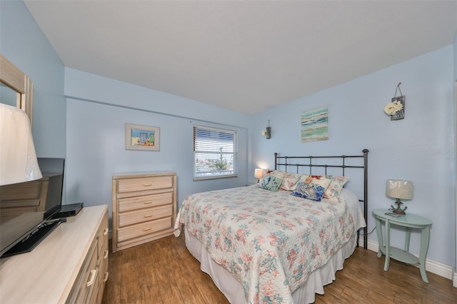 bedroom with dark wood-type flooring