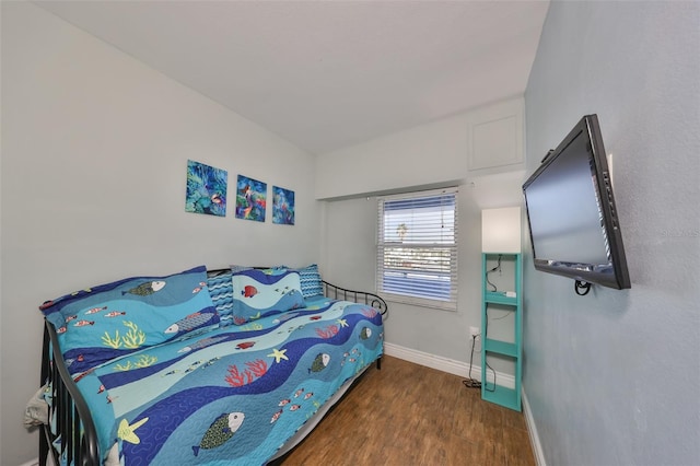 bedroom with dark wood-type flooring