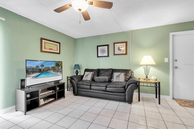 living room with light tile patterned floors, a textured ceiling, and ceiling fan