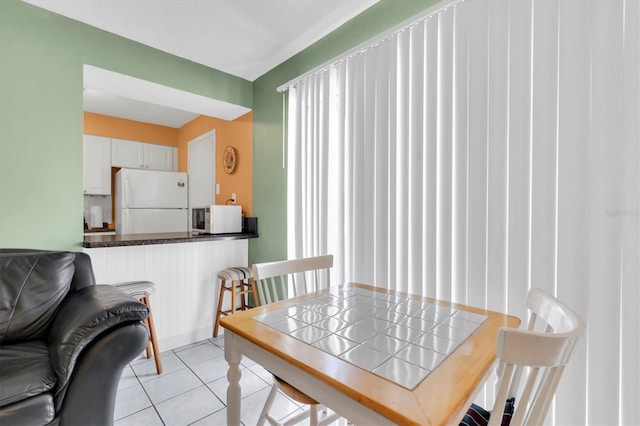 dining area featuring light tile patterned floors