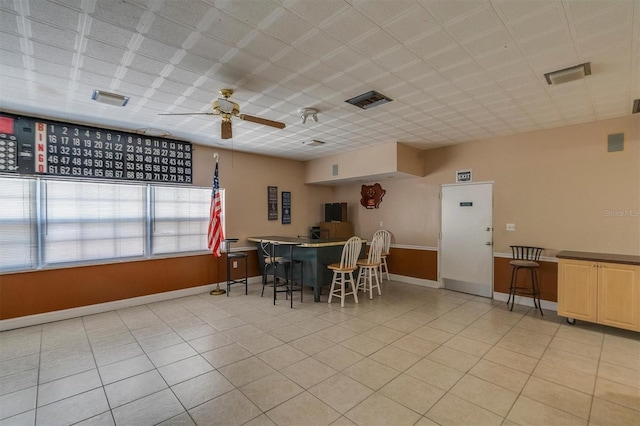 dining space with ceiling fan and light tile patterned flooring