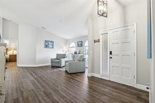 foyer featuring vaulted ceiling, a chandelier, and dark hardwood / wood-style floors