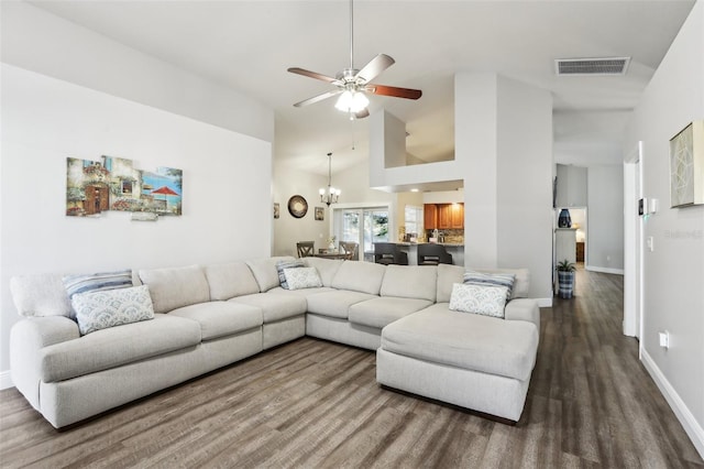 living room featuring high vaulted ceiling, ceiling fan with notable chandelier, and hardwood / wood-style flooring