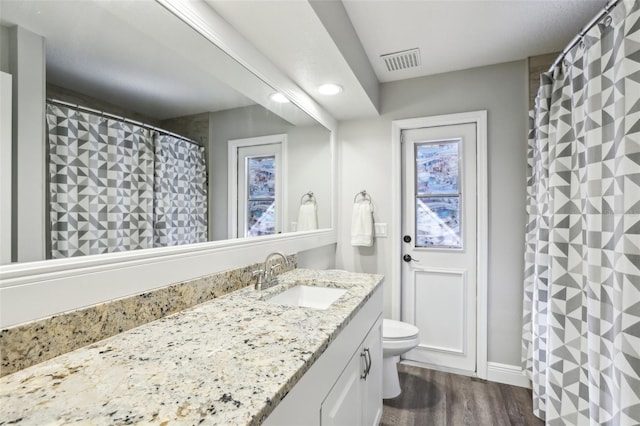 bathroom featuring hardwood / wood-style floors, vanity, and toilet