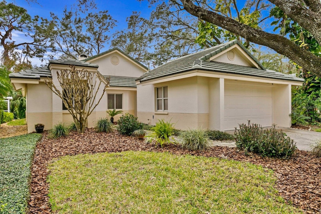 view of front facade with a front yard and a garage