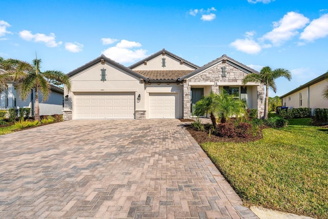 view of front of property with a front yard and a garage