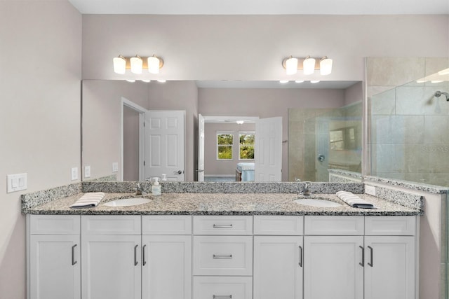 bathroom with vanity and a shower with shower door