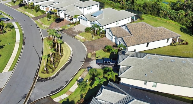 aerial view of property and surrounding area featuring nearby suburban area