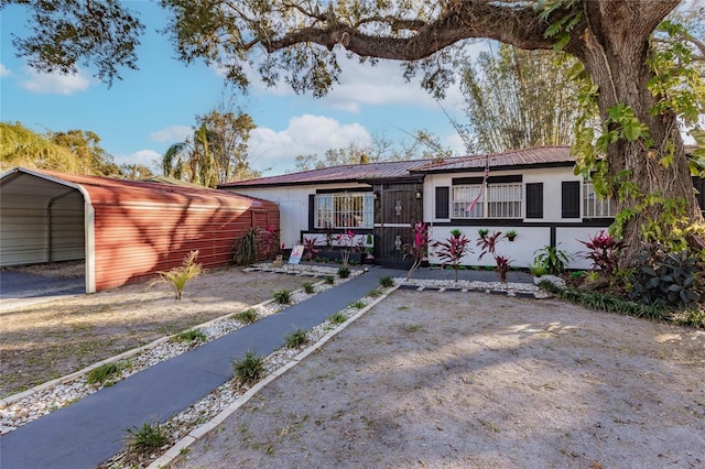 2005 E Crenshaw St, Tampa, FL 33610 - ranch-style home featuring a carport