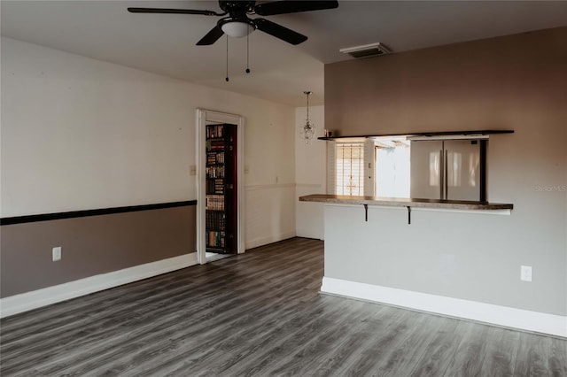 2005 E Crenshaw St, Tampa, FL 33610 - empty room with ceiling fan with notable chandelier and dark wood-type flooring