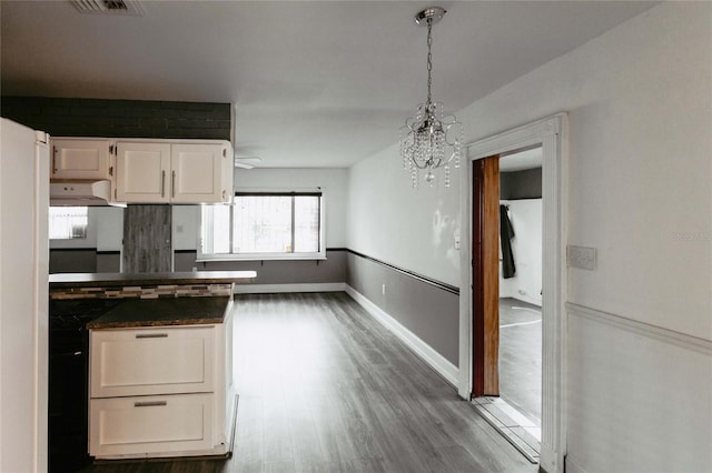 2005 E Crenshaw St, Tampa, FL 33610 - kitchen with white cabinets, pendant lighting, a notable chandelier, and dark wood-type flooring