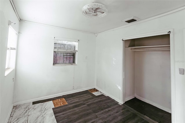 2005 E Crenshaw St, Tampa, FL 33610 - unfurnished bedroom featuring a closet and multiple windows