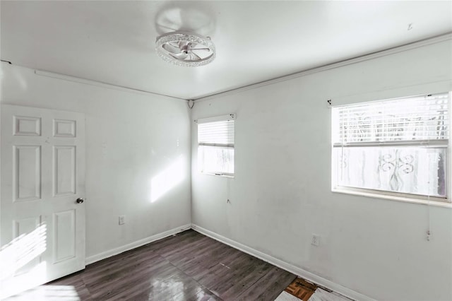 2005 E Crenshaw St, Tampa, FL 33610 - unfurnished room featuring a healthy amount of sunlight, dark wood-type flooring, and crown molding