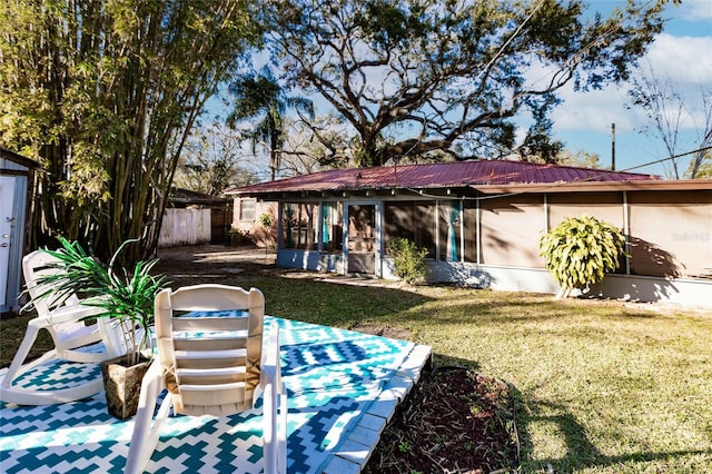 2005 E Crenshaw St, Tampa, FL 33610 - rear view of house featuring a yard