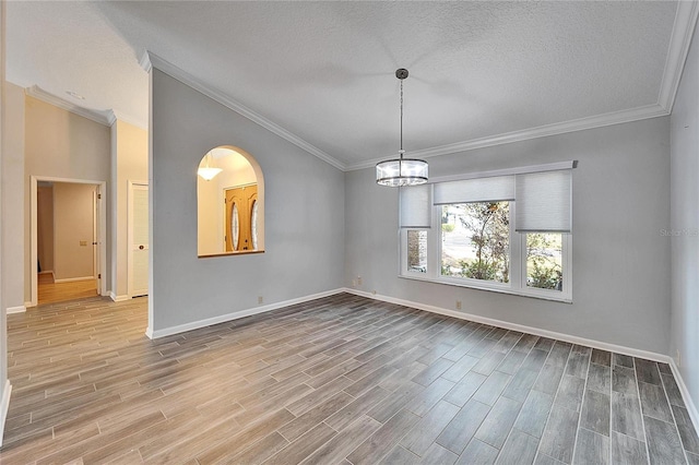 unfurnished dining area with wood-type flooring, a textured ceiling, a chandelier, and crown molding