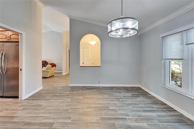 unfurnished dining area featuring ornamental molding, light hardwood / wood-style flooring, and a notable chandelier