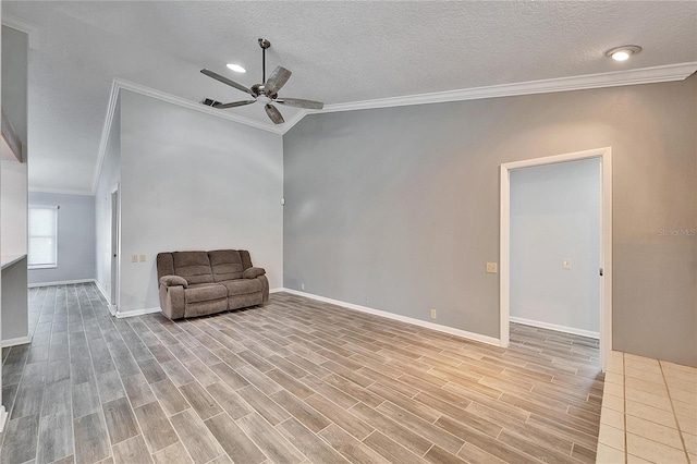 unfurnished room featuring lofted ceiling, a textured ceiling, ceiling fan, and ornamental molding