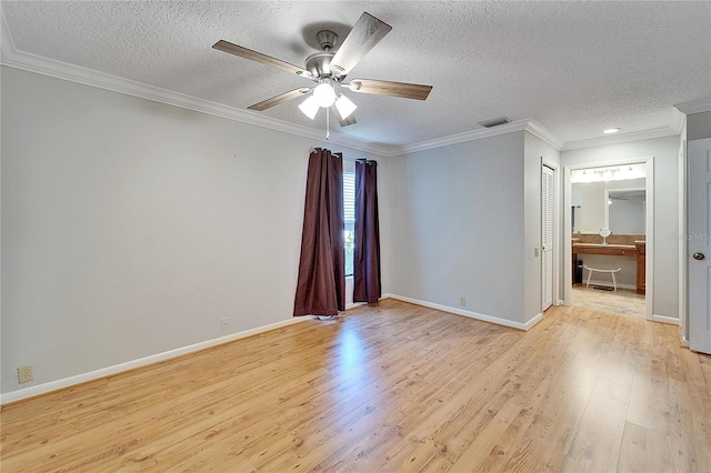 empty room featuring a textured ceiling, ceiling fan, crown molding, and light hardwood / wood-style flooring