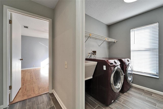 laundry area featuring washer and dryer and a textured ceiling