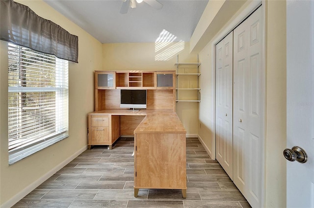 unfurnished office with ceiling fan and a healthy amount of sunlight