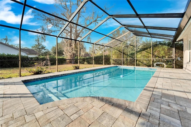 view of swimming pool featuring a lanai and a patio area