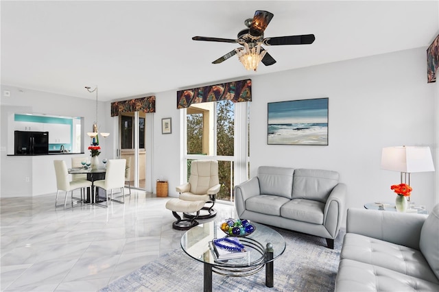 living room featuring ceiling fan with notable chandelier