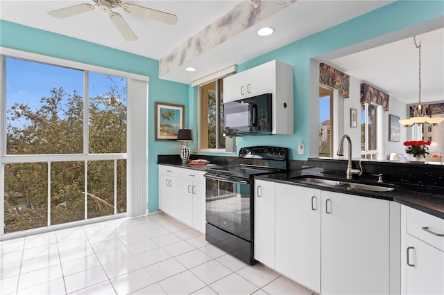 kitchen with ceiling fan, pendant lighting, black appliances, sink, and white cabinetry