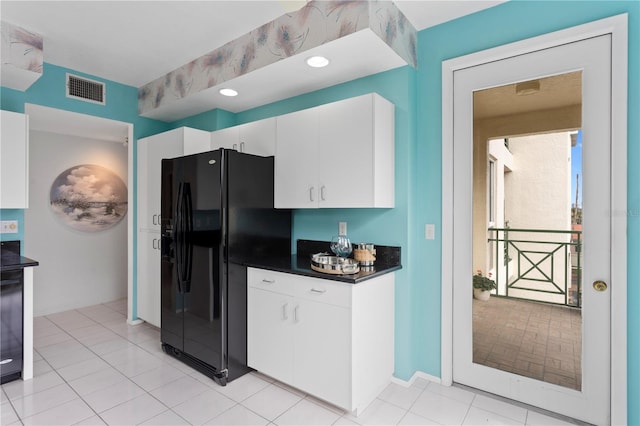 kitchen featuring light tile patterned floors, white cabinets, and black fridge with ice dispenser