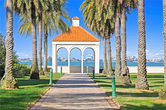 view of community featuring a water view and a yard