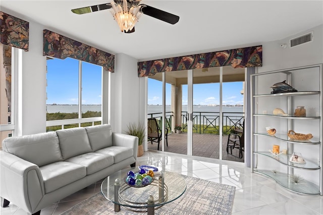 living room featuring a water view and ceiling fan